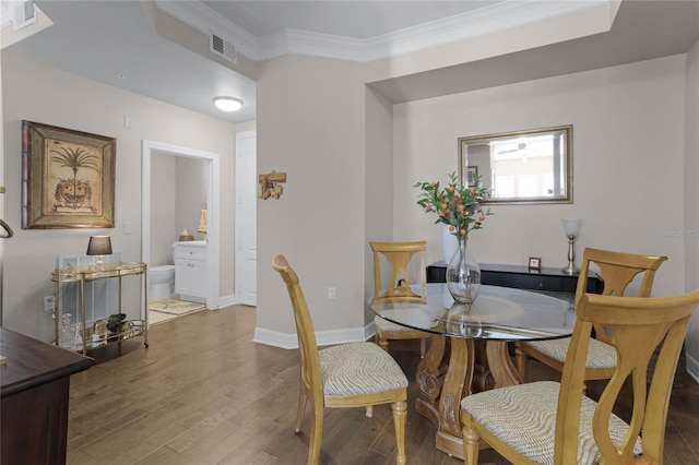 501 Mirasol Cir Unit 304, Kissimmee, FL 34747 - dining space featuring wood finished floors and ornamental molding