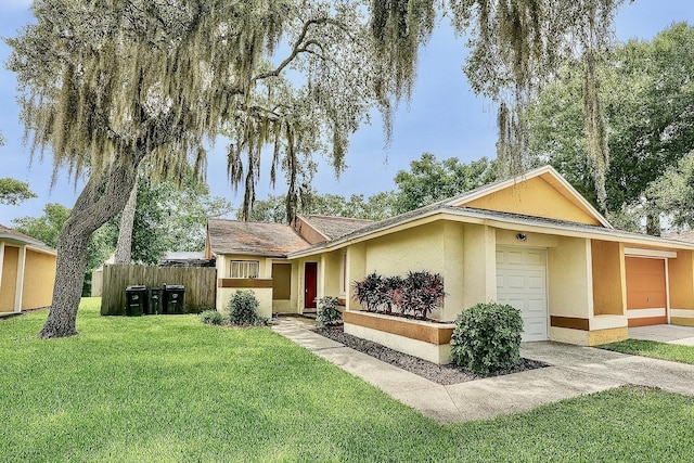 2242 Atrium Cir, Orlando, FL 32808 - view of front of home with an attached garage, stucco siding, and driveway