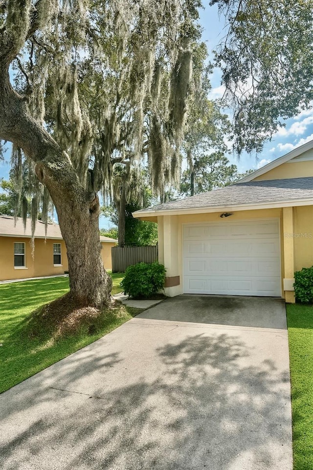 2242 Atrium Cir, Orlando, FL 32808 - view of front of home with stucco siding, driveway, and an attached garage