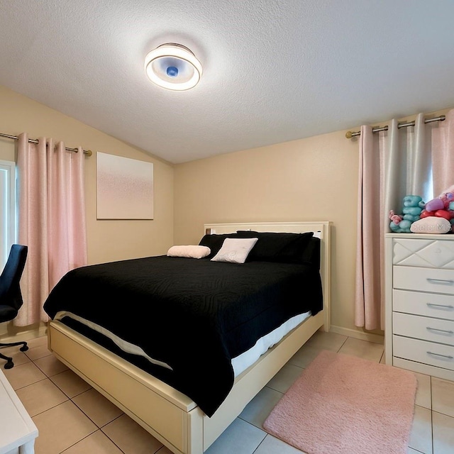 2242 Atrium Cir, Orlando, FL 32808 - bedroom featuring light tile patterned flooring, vaulted ceiling, and a textured ceiling