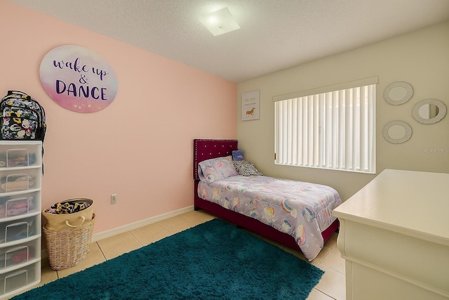 2242 Atrium Cir, Orlando, FL 32808 - tiled bedroom featuring baseboards and a textured ceiling