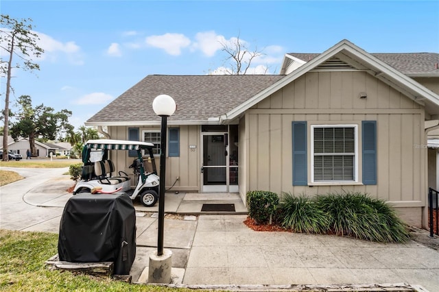 1339 Villa Ln Unit 50, Apopka, FL 32712 - view of front of home featuring a shingled roof and board and batten siding