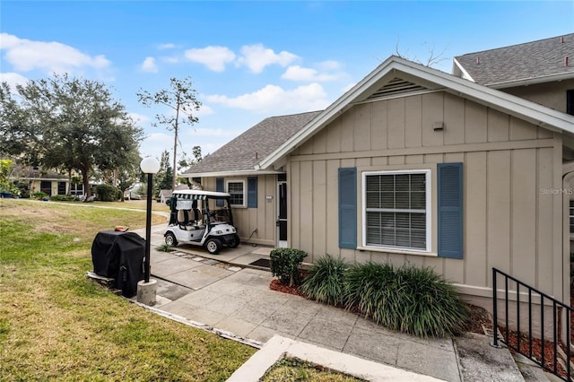 1339 Villa Ln Unit 50, Apopka, FL 32712 - view of side of property with a yard, roof with shingles, and board and batten siding