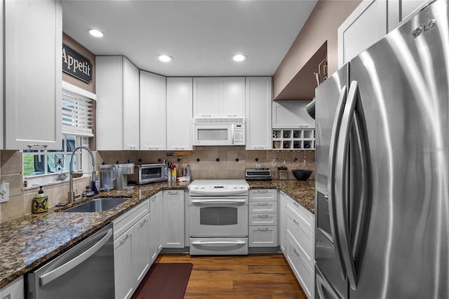 1339 Villa Ln Unit 50, Apopka, FL 32712 - kitchen featuring stainless steel appliances, white cabinetry, dark wood-style floors, decorative backsplash, and recessed lighting
