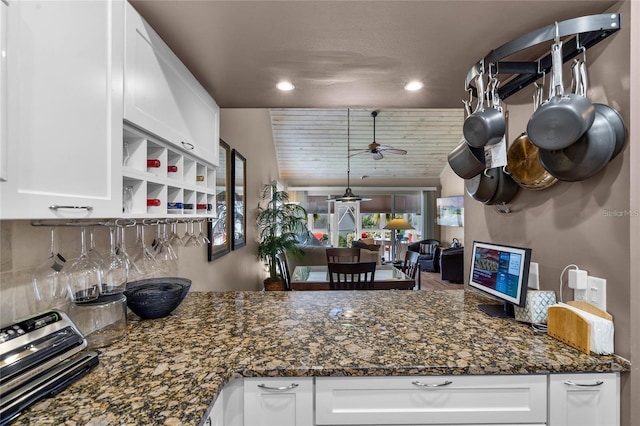 1339 Villa Ln Unit 50, Apopka, FL 32712 - kitchen with white cabinets, ceiling fan, decorative backsplash, recessed lighting, and dark stone countertops