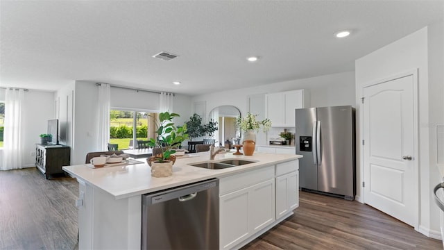 3308 Wynwood Forest Dr, Ocoee, FL 34761 - kitchen with appliances with stainless steel finishes, an island with sink, white cabinets, light countertops, and dark wood-type flooring