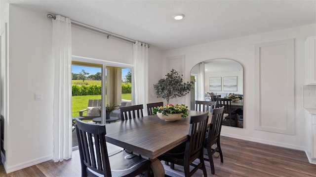 3308 Wynwood Forest Dr, Ocoee, FL 34761 - dining space with arched walkways, dark wood-type flooring, and recessed lighting