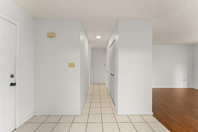 17 Rosewood Dr, Davenport, FL 33837 - hallway featuring a textured ceiling and light tile patterned floors