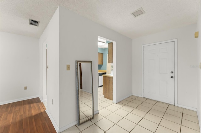 17 Rosewood Dr, Davenport, FL 33837 - entryway with a textured ceiling and light wood finished floors
