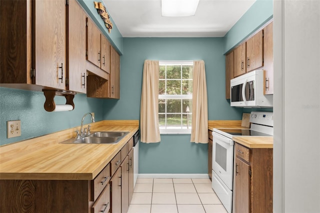 17 Rosewood Dr, Davenport, FL 33837 - kitchen with white appliances and light tile patterned floors
