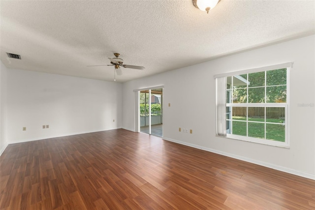 17 Rosewood Dr, Davenport, FL 33837 - unfurnished room with wood finished floors, a ceiling fan, and a textured ceiling