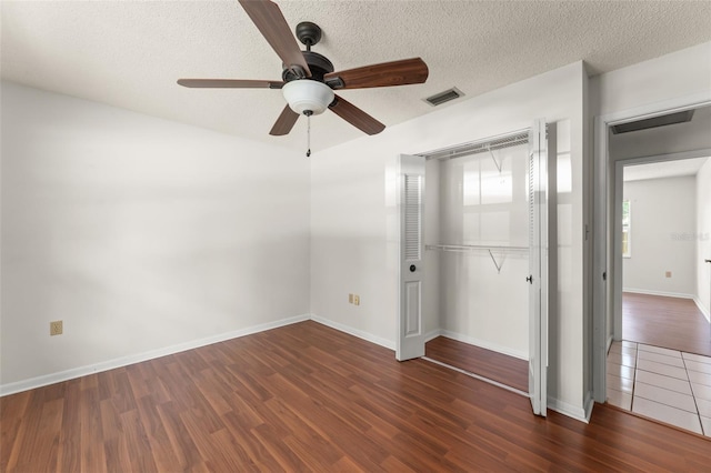 17 Rosewood Dr, Davenport, FL 33837 - unfurnished bedroom featuring a closet, wood finished floors, a textured ceiling, and ceiling fan