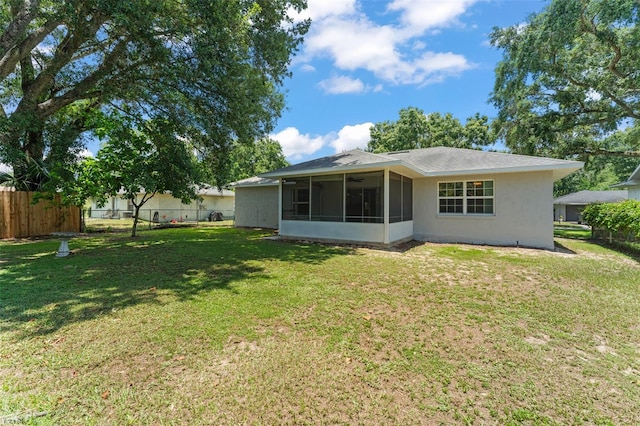 17 Rosewood Dr, Davenport, FL 33837 - rear view of house with a sunroom and stucco siding