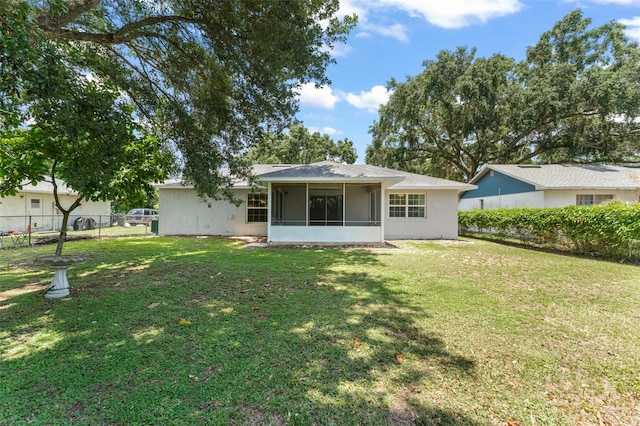 17 Rosewood Dr, Davenport, FL 33837 - back of property featuring a sunroom and stucco siding