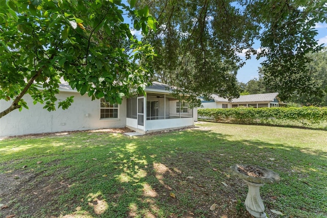 17 Rosewood Dr, Davenport, FL 33837 - back of property with a sunroom, a yard, and stucco siding
