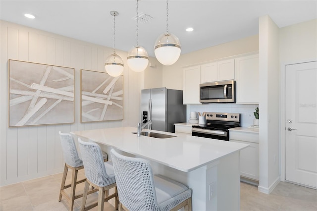 2304 Southbury Dr, Kissimmee, FL 34744 - kitchen with appliances with stainless steel finishes, decorative backsplash, light countertops, a breakfast bar, and recessed lighting