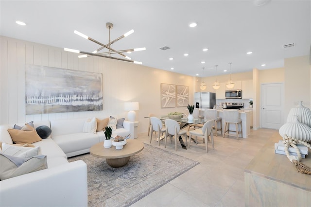 2304 Southbury Dr, Kissimmee, FL 34744 - living room with a chandelier, recessed lighting, and light tile patterned floors