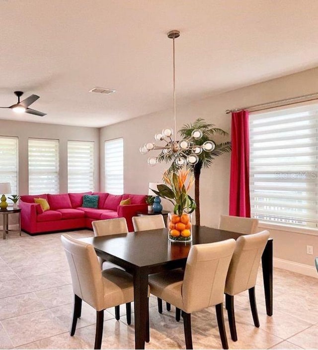 13542 Gorgona Isle Dr, Windermere, FL 34786 - dining space featuring light tile patterned flooring, a chandelier, and a ceiling fan