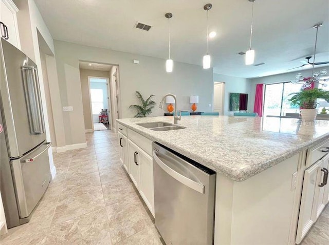 13542 Gorgona Isle Dr, Windermere, FL 34786 - kitchen with appliances with stainless steel finishes, an island with sink, white cabinets, and hanging light fixtures