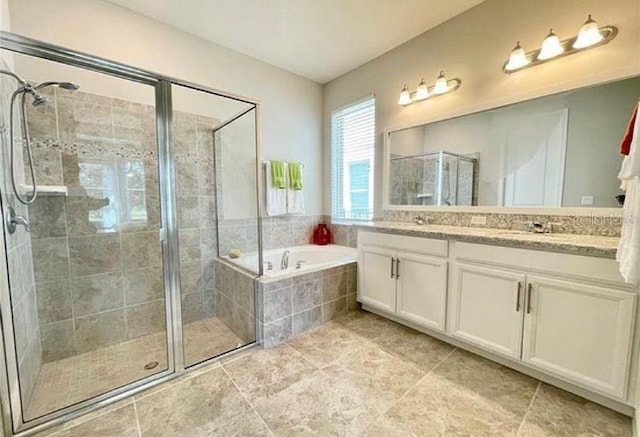 13542 Gorgona Isle Dr, Windermere, FL 34786 - full bath featuring double vanity, a shower stall, a garden tub, and tile patterned flooring