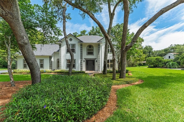 109 E 12th Ave, Windermere, FL 34786 - neoclassical home with stucco siding, a front lawn, and roof with shingles