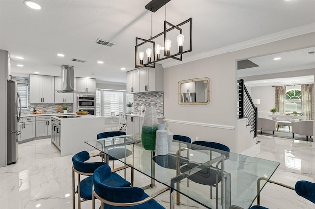 109 E 12th Ave, Windermere, FL 34786 - dining room with plenty of natural light, light marble finish flooring, crown molding, recessed lighting, and a chandelier