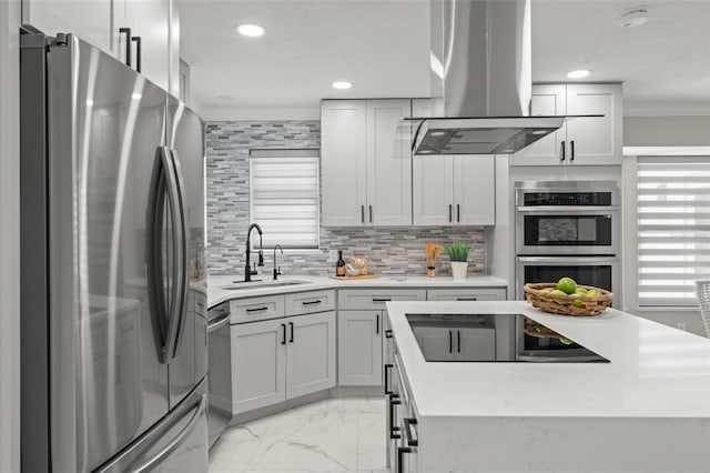 109 E 12th Ave, Windermere, FL 34786 - kitchen featuring appliances with stainless steel finishes, island range hood, light marble finish floors, crown molding, and tasteful backsplash