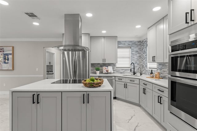 109 E 12th Ave, Windermere, FL 34786 - kitchen featuring light marble finish flooring, stainless steel appliances, island range hood, a kitchen island, and ornamental molding