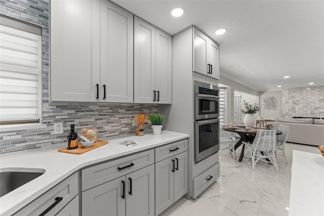 109 E 12th Ave, Windermere, FL 34786 - kitchen with double oven, tasteful backsplash, light marble finish flooring, and recessed lighting