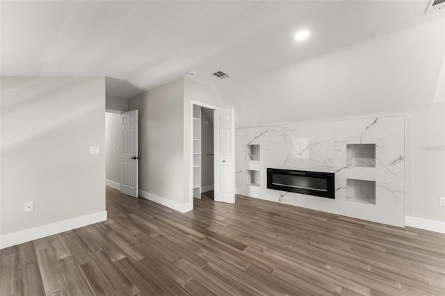 109 E 12th Ave, Windermere, FL 34786 - unfurnished living room featuring wood finished floors, a premium fireplace, and lofted ceiling