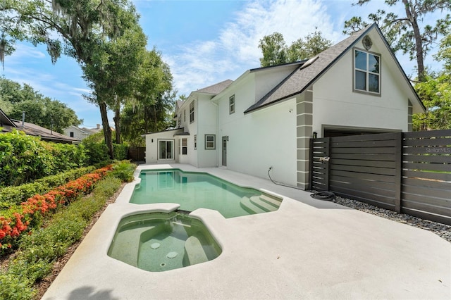 109 E 12th Ave, Windermere, FL 34786 - view of swimming pool featuring a pool with connected hot tub, a fenced backyard, and a patio area