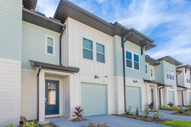 1030 Plantation Ln, Davenport, FL 33896 - view of front of house featuring an attached garage, board and batten siding, and driveway