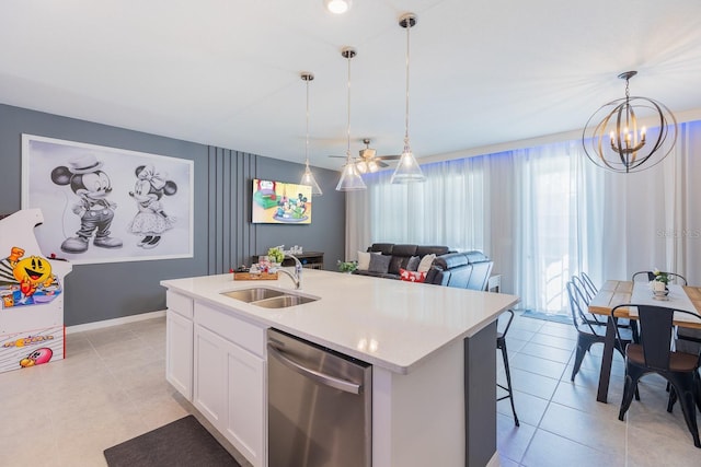 1030 Plantation Ln, Davenport, FL 33896 - kitchen with stainless steel dishwasher, light countertops, a center island with sink, hanging light fixtures, and white cabinetry
