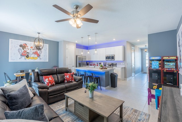 1030 Plantation Ln, Davenport, FL 33896 - living room featuring a chandelier, a ceiling fan, and light tile patterned floors