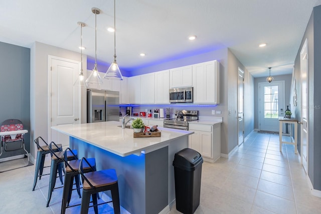 1030 Plantation Ln, Davenport, FL 33896 - kitchen with appliances with stainless steel finishes, a breakfast bar, light countertops, white cabinetry, and recessed lighting