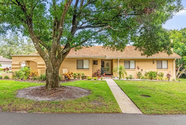 1157 E Winged Foot Cir, Winter Springs, FL 32708 - ranch-style house featuring a front yard, stucco siding, and a tiled roof