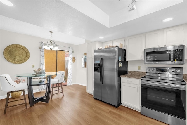 1157 E Winged Foot Cir, Winter Springs, FL 32708 - kitchen featuring stainless steel appliances, light wood-type flooring, a chandelier, white cabinets, and recessed lighting