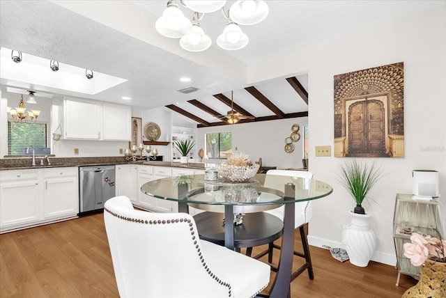 1157 E Winged Foot Cir, Winter Springs, FL 32708 - kitchen featuring a chandelier, stainless steel dishwasher, light wood-style floors, and white cabinetry