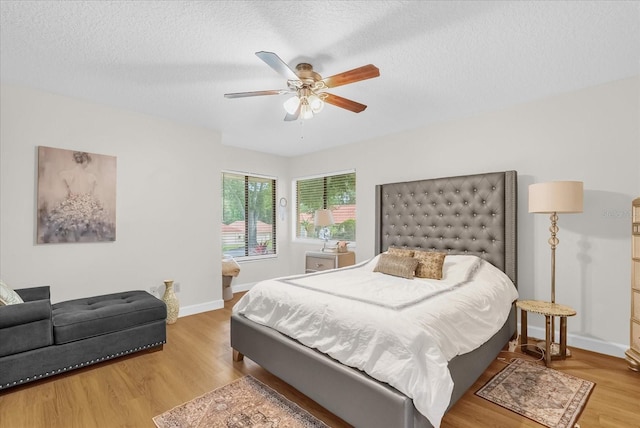 1157 E Winged Foot Cir, Winter Springs, FL 32708 - bedroom with light wood-type flooring, a textured ceiling, and a ceiling fan