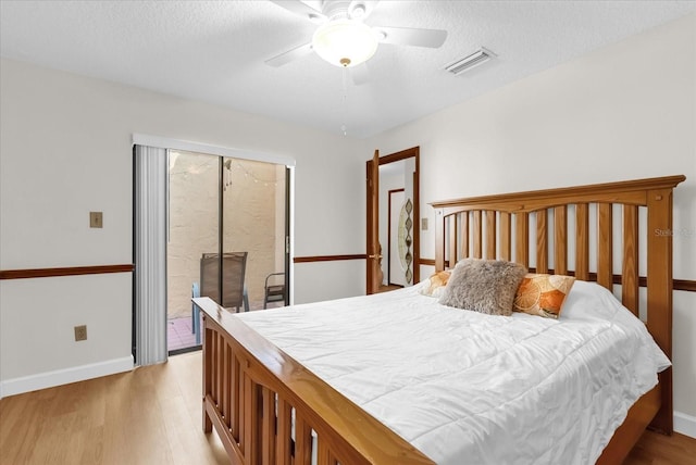 1157 E Winged Foot Cir, Winter Springs, FL 32708 - bedroom featuring access to outside, wood finished floors, a textured ceiling, and a ceiling fan