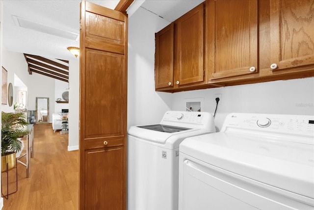 1157 E Winged Foot Cir, Winter Springs, FL 32708 - washroom featuring cabinet space, separate washer and dryer, and light wood-style flooring