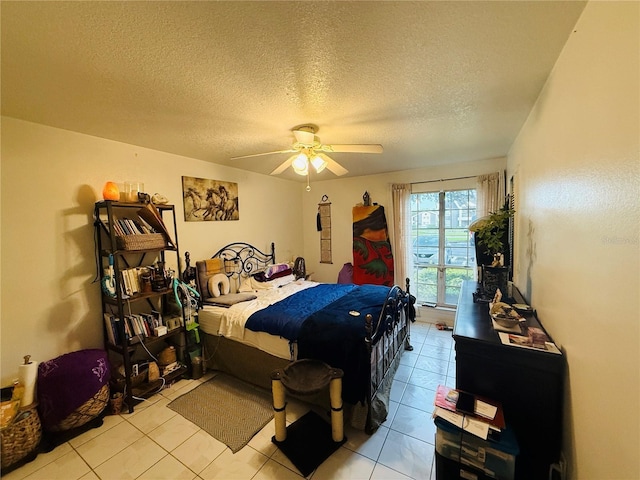 4690 Sussex Ter Unit 103, Orlando, FL 32811 - bedroom with light tile patterned flooring, a textured ceiling, and a ceiling fan