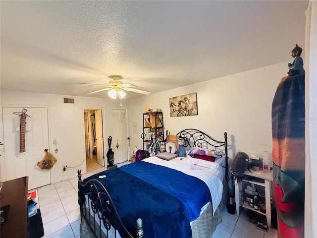 4690 Sussex Ter Unit 103, Orlando, FL 32811 - tiled bedroom featuring ceiling fan and a textured ceiling