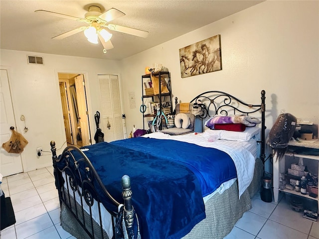 4690 Sussex Ter Unit 103, Orlando, FL 32811 - tiled bedroom featuring a closet, ceiling fan, and a textured ceiling