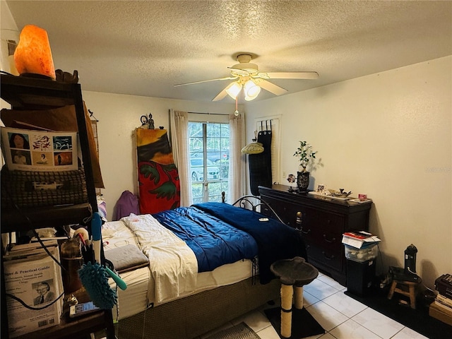 4690 Sussex Ter Unit 103, Orlando, FL 32811 - bedroom with a textured ceiling, a ceiling fan, and light tile patterned floors