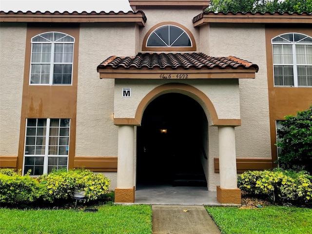 4690 Sussex Ter Unit 103, Orlando, FL 32811 - property entrance featuring stucco siding and a tiled roof