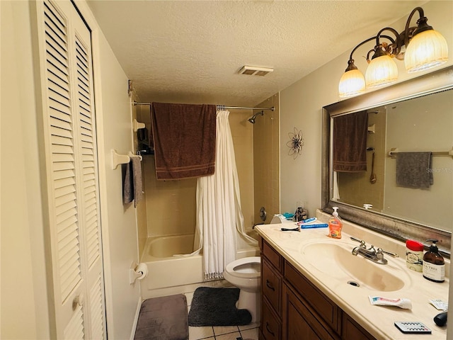 4690 Sussex Ter Unit 103, Orlando, FL 32811 - full bathroom featuring a closet, shower / bath combo, vanity, a textured ceiling, and tile patterned floors