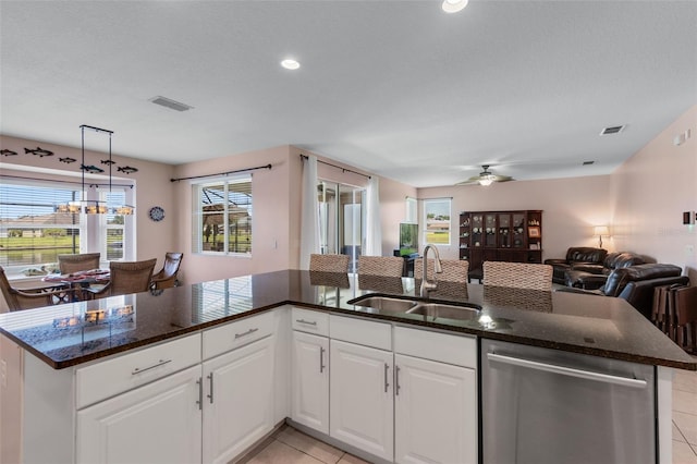 1758 Boat Launch Rd, Kissimmee, FL 34746 - kitchen with dishwasher, ceiling fan, open floor plan, light tile patterned floors, and white cabinetry