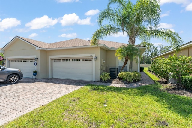 1218 Vienna Square Dr, Winter Haven, FL 33884 - ranch-style house featuring a garage, decorative driveway, a front yard, and stucco siding