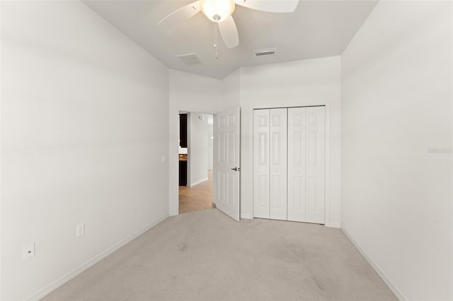 1218 Vienna Square Dr, Winter Haven, FL 33884 - unfurnished bedroom with light colored carpet, a closet, and a ceiling fan